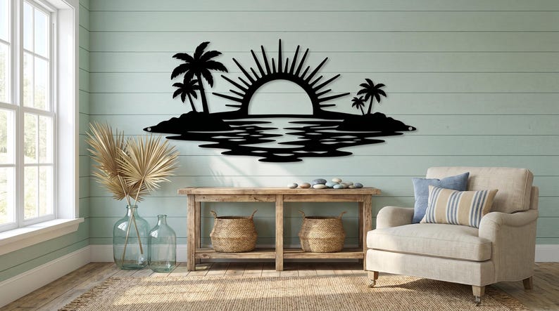 May include: A black metal wall art piece featuring a tropical island scene with a rising sun, palm trees on both sides, and a reflective water pattern below. The design is a flat, silhouette-style cutout mounted horizontally on a wall surface.