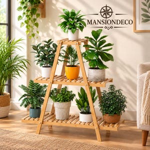 May include: A three-tiered A-frame bamboo plant stand holding eight potted plants of various sizes and foliage types. The stand features a slatted design and light wood finish. The text MANSIONDECO with a compass logo is visible on the wall.