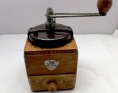 A vintage Peugeot coffee grinder with bakelite lid, kitchenware