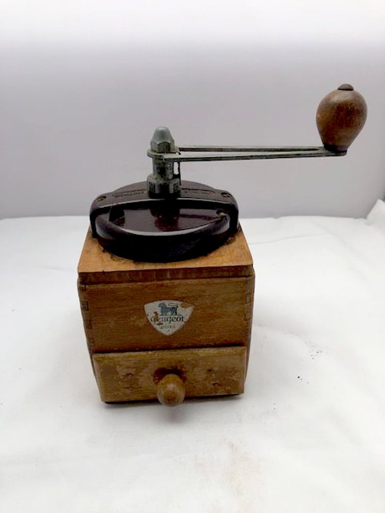 A vintage Peugeot coffee grinder with bakelite lid kitchenware