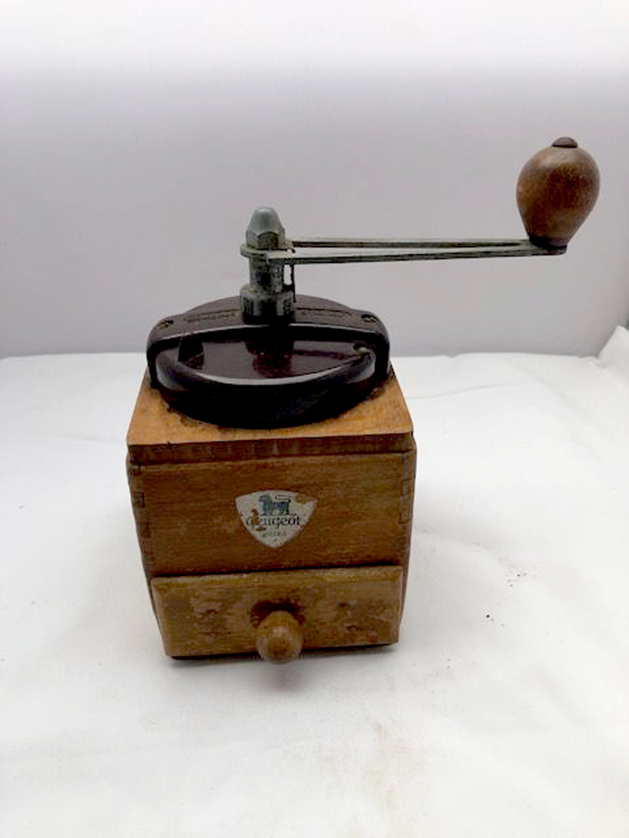 A vintage Peugeot coffee grinder with bakelite lid kitchenware
