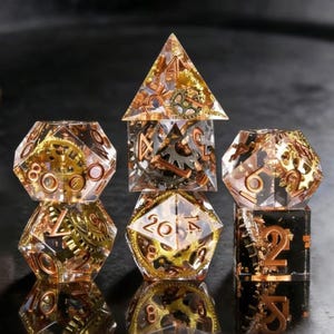 May include: A set of seven polyhedral dice with a steampunk aesthetic. The dice are clear with embedded bronze and gold-colored gears and numbers. The dice include a pyramid, a cube, a d8, a d10, a d12, a d20, and a d6.
