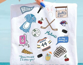 May include: A white t-shirt featuring a collage of colourful illustrations including a blue diner uniform, hockey sticks, a pink music player, a jersey with the name Graham and number 44, a slice of pizza, and text reading Off Campus.