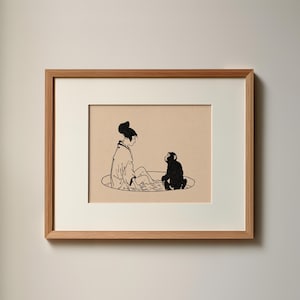 May include: A framed print featuring a black ink illustration on a beige background. The artwork depicts a person with hair in a bun wearing a robe, sitting in a circular pool alongside a small monkey. The frame is made of light-colored wood.