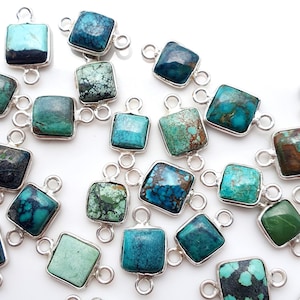 May include: A collection of square turquoise gemstone connectors, each featuring a silver-toned metal loop on two opposite sides. The stones display various shades of blue, green, and teal with unique natural matrix patterns and textures.