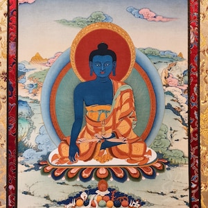 May include: A detailed painting of a seated Buddha figure with blue skin, wearing an orange robe, and surrounded by a red halo. The background features a blue sky with clouds and mountains. The artwork is framed with a red border.