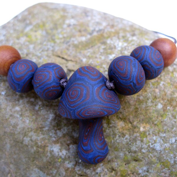 Mens mushroom pendant necklace, handmade with blue and black and red brown swirls and spiral designs, on thin adjustable cord