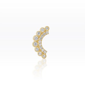 May include: A gold ear cuff with a curved design. The ear cuff features a series of round, clear gemstones set along its curve, with a scalloped edge. The jewellery is displayed on a white background.
