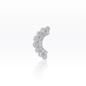 May include: A silver-coloured earring with a series of small, round, clear gemstones. The design features a crescent shape with a scalloped edge, creating a sparkling, elegant look. The earring is set against a white background.