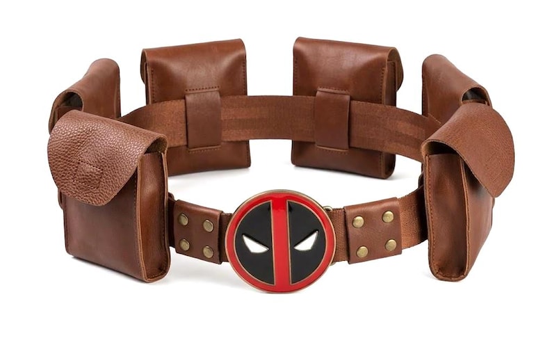 May include: A white ceramic mug with a black handle and the text "But First, Coffee" in a black, bold font. The mug is on a white surface. The mug is approximately 4 inches tall.