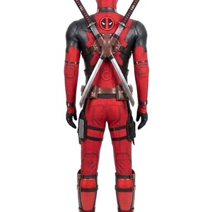 May include: Red and black Deadpool costume with a mask, featuring a chest emblem and two katana swords strapped to the back. The costume includes gloves, boots, and a utility belt. The overall design is a detailed replica of the character's attire.