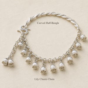 May include: A silver-toned bracelet featuring a twisted curved half-bangle connected to a chain adorned with multiple hanging lily-shaped charms. The text Curved Half-Bangle and Lily Charm Chain is visible on the image, describing the components.
