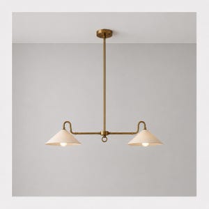May include: A brass linear chandelier featuring a central vertical rod connected to a horizontal bar with two downward-facing conical shades. Each shade is topped with a curved arm and contains a single light bulb, creating a balanced fixture.