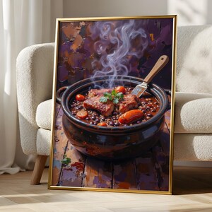 May include: A framed wall art print featuring a dark ceramic pot filled with a hearty stew of black beans, sliced sausages, and tomatoes. Steam rises from the hot dish, which is garnished with fresh green herbs and served with a wooden spoon.