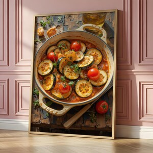 May include: A framed wall art print featuring a top-down view of a cream-colored ceramic pot filled with a cooked vegetable stew. The dish contains sliced zucchini, bright red cherry tomatoes, and green herbs in a rich, orange-red tomato sauce.