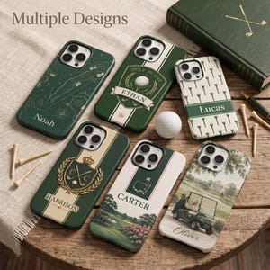 May include: Six smartphone cases featuring golf-themed designs, including patterns with golf balls, tees, and course landscapes. Each case is personalized with names like Noah, Ethan, Lucas, Harrison, Carter, and Oliver. A white golf ball and wooden tees are placed among the cases on a wooden surface.