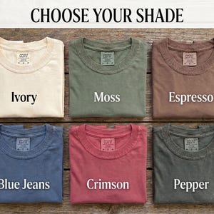 Choose Your Shade card displaying all six Comfort Colors options for the Scattered Kitchen Herbs T-Shirt: Ivory, Moss, Espresso, Blue Jeans, Crimson, and Pepper, in a Victorian apothecary-style chart. By MythicThreadMagic.