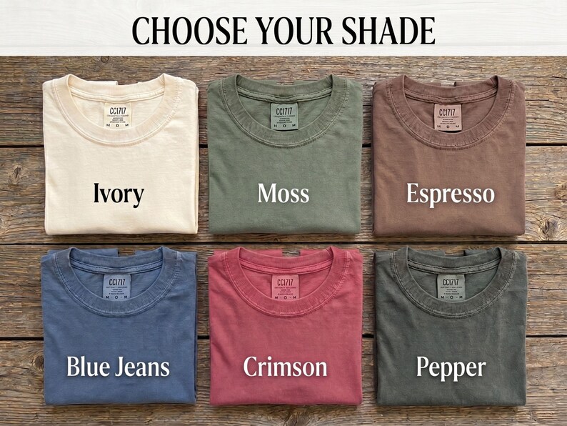 Choose Your Shade card displaying all six Comfort Colors options for the Scattered Kitchen Herbs T-Shirt: Ivory, Moss, Espresso, Blue Jeans, Crimson, and Pepper, in a Victorian apothecary-style chart. By MythicThreadMagic.