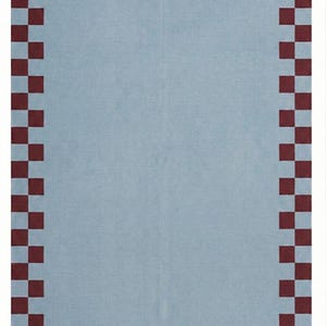 May include: A rectangular textile with a light blue center and a border of alternating dark red and light blue squares. The checkered border frames the solid blue interior, creating a simple yet visually appealing design. The textile is likely a rug or a decorative cloth.