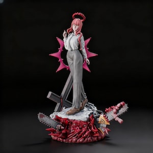 May include: A detailed figurine of a character with pink hair, wearing a white shirt and gray pants, standing on a base with a chainsaw and a cross. The figure has a halo and a pink star-shaped design behind it. The base is red.