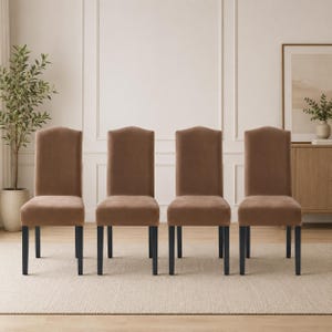 May include: Four brown upholstered dining chairs with black legs are arranged in a row. The chairs have a curved top and a simple, elegant design. The chairs are set on a neutral-colored rug.