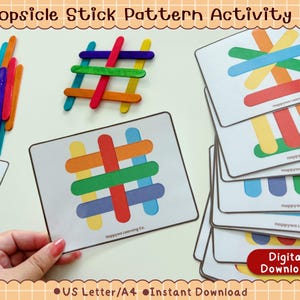 May include: A Popsicle Stick Pattern Activity #1 set featuring a stack of white cards with colorful popsicle stick designs, a pile of loose multi-colored wooden sticks, and a grid pattern made of sticks. Each card displays Happywa Learning Co.