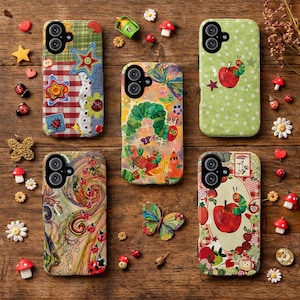 May include: A collection of colorful phone cases with various designs, including a patchwork pattern, a green caterpillar, and a whimsical fruit and vegetable scene. Decorative elements like butterflies, ladybugs, and mushrooms surround the cases.
