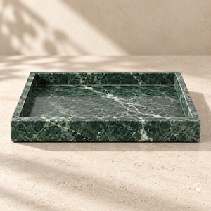 May include: A rectangular tray crafted from dark green marble featuring natural white veining throughout the surface. The tray has a flat base and raised, straight edges, showcasing the polished stone texture and deep forest green color palette.