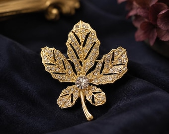 Vintage bladbroche, goudkleurige kristallen strassspeld, op de natuur geïnspireerde statement-sieraden