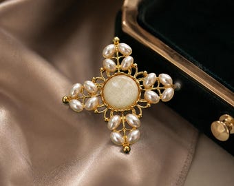 Vintage kruisbroche, goudkleurige nepparel en glitterpin in het midden, elegante religieuze statement-sieraden