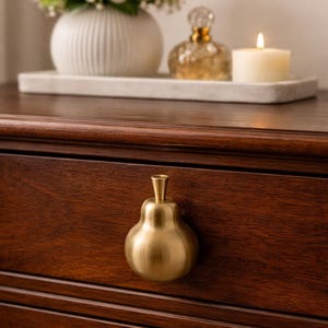 May include: A set of three ceramic mugs with a speckled, matte finish. Each mug features a different color: light blue, cream, and gray. The mugs have a simple, modern design with a rounded shape and a comfortable handle.