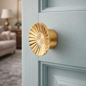 May include: A set of three ceramic canisters with lids. The canisters are white with a textured surface and feature a geometric pattern in shades of blue and gray. The lids are a matching white.