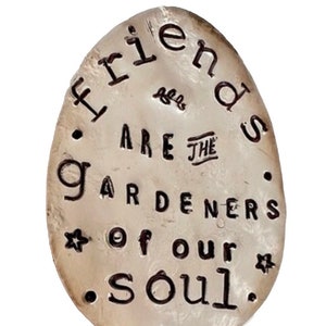 Garden marker made from recycled silver plate spoon flattened and hand stamped with the words ’Friends are the Gardeners of Our Soul' with decorative dots and stamps.