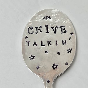 May include: A silver spoon with the words "CHIVE TALKIN'" engraved on it. The spoon is decorated with small stars.