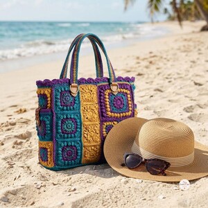 May include: A crochet tote bag constructed from multicolored granny squares in shades of teal, mustard yellow, and purple, featuring two matching handles, a scalloped top edge, and a straw sun hat with dark brown tortoiseshell sunglasses.
