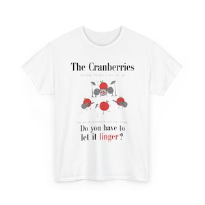May include: White t-shirt with the words "The Cranberries" and a cartoon band of cranberries playing instruments. The shirt also features the lyrics "Do you have to let it linger?"