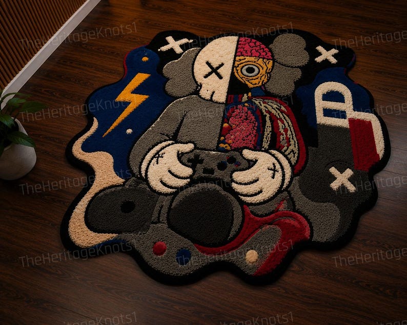 May include: A vibrant, cartoon rug depicting a character with a skull and brain design, holding a game controller. The rug's color palette includes blue, grey, and red, with a lightning bolt and other graphic elements.
