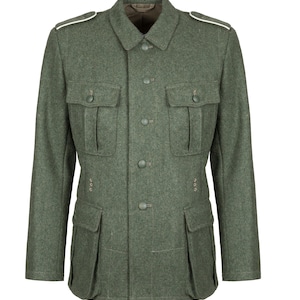 May include: A field-grey wool military-style jacket featuring a fold-down collar, four front pockets with buttoned flaps, a central button-down placket, and shoulder epaulets with white piping. The garment includes small metal ventilation eyelets.