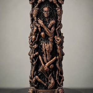 May include: A cylindrical sculpture with a metallic copper finish featuring intricate relief carvings of human figures and faces. The central design depicts a central figure surrounded by multiple intertwined bodies, with sculpted heads at the top and base.
