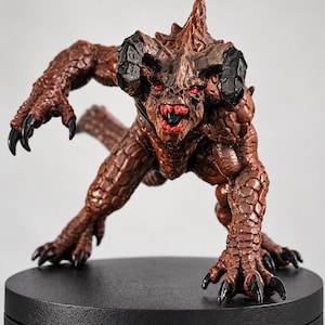 May include: A brown, reptilian creature figurine with a textured, scaly body, sharp black claws, and prominent black horns. The creature has glowing red eyes and an open mouth revealing sharp teeth, posed in a low, aggressive stance.