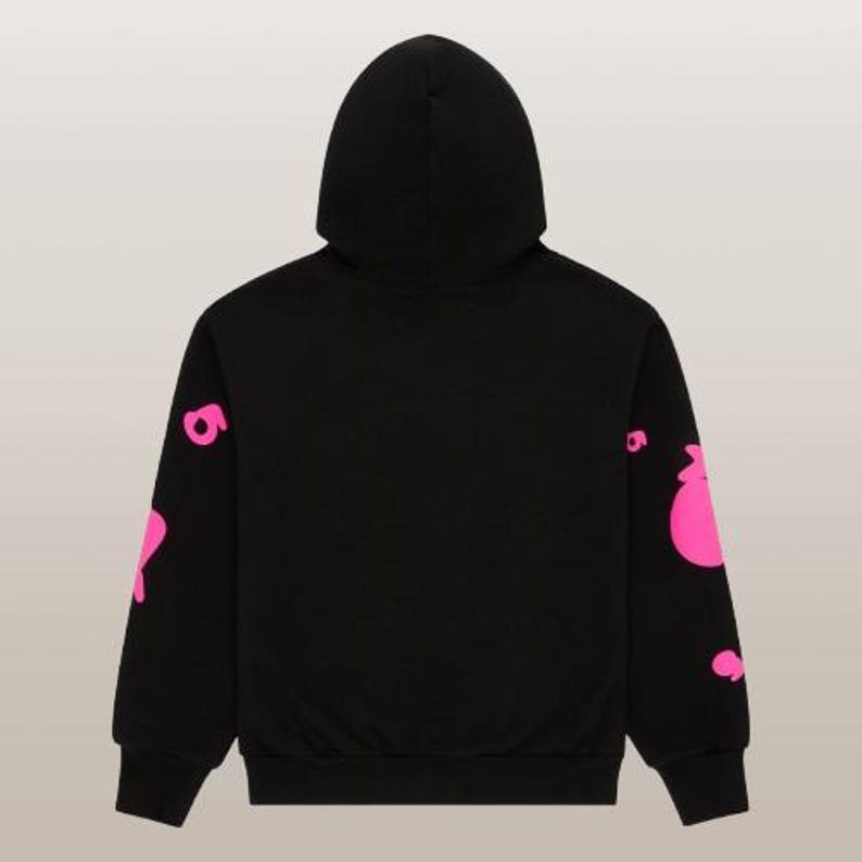 May include: Black hoodie with a hood and long sleeves. The sleeves feature a pink graphic design. The hoodie is made of a soft material and is suitable for casual wear. The back view of the hoodie is shown.
