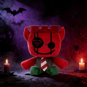 May include: A red plush toy with a castle-like head, devil horns, and a smiling face with a monocle and eye patch. It wears a gray vest, a red and white striped tie, and green feet. The Halloween-themed toy is set against a purple and black background with bats and spiders.