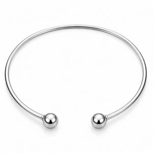 May include: A silver-toned metal cuff bracelet featuring a smooth, circular band with an open design. The two ends of the bracelet are finished with polished, spherical ball terminals that provide a clean and reflective surface appearance.