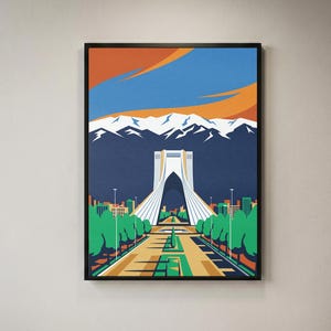 May include: A framed art print featuring a stylized illustration of the Azadi Tower in Tehran. The scene depicts the white monument centered against a dark blue sky with orange clouds and snow-capped mountains, with green trees and a path below.