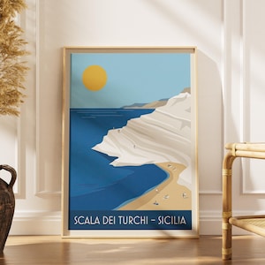 May include: Framed art print depicting a coastal scene with a yellow sun, blue sea, and white cliffs. The print includes the text "SCALA DEI TURCHI - SICILIA" at the bottom. The artwork is displayed in a light wood frame.