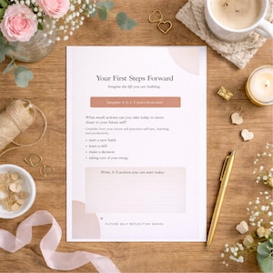 May include: A white ceramic mug with a black handle and the text "But First, Coffee" in a black, handwritten-style font. The mug is on a white surface.