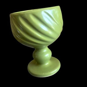 May include: A set of three ceramic mugs with a speckled, matte finish. The mugs are in shades of cream, light grey, and dark grey. Each mug has a simple, minimalist design, ideal for coffee or tea.