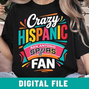 May include: Black t-shirt with a colorful graphic design. The design includes the words "Crazy Hispanic" in white and teal, "San Antonio Spurs" in white and pink, and "Fan" in white. The text "Digital File" is at the bottom.