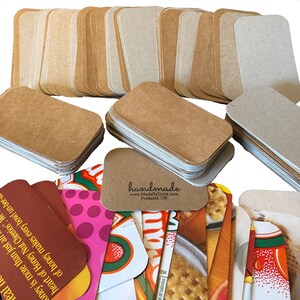 May include: A stack of 50 blank, brown, rounded-corner gift tags with the text "handmade" and website address "www.MadeByTricia.com" and location "Portland, OR".