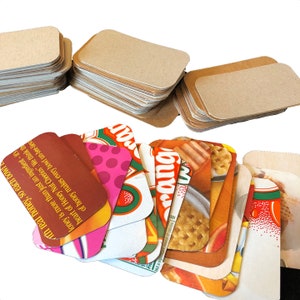 May include: A stack of blank brown cardstock note cards and a stack of colourful cards with images of cereal boxes and the text "Honey Nut Cheerios" and "rang".
